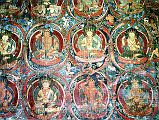 Tibet Guge 03 Tholing 04 Red Temple Many Images Along the left hand wall are floor-to-ceiling rows of deities entwined in wreath-like borders each interleaving into a whole organic complex across the entire space. Photo - Thni: Westtibet.